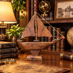 Wooden sailboat model displayed as nautical desk decor