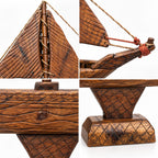 Handcrafted wooden sailing boat with detailed sails