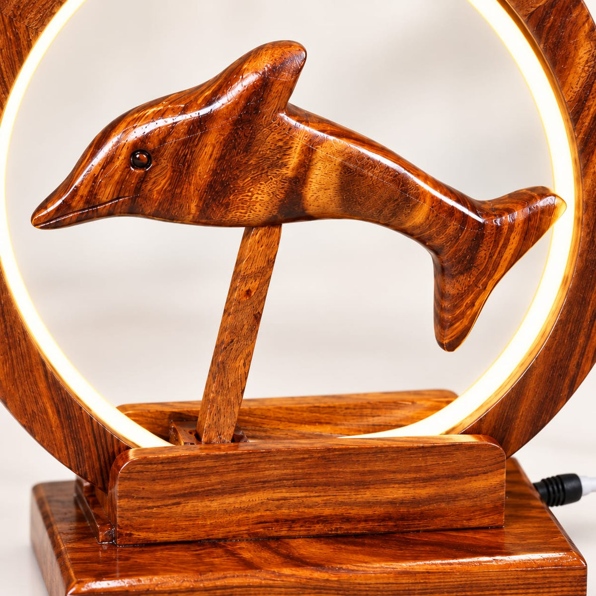 Handcrafted wooden dolphin lamp with warm circular light